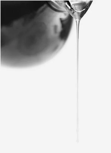 A drop of serum falling onto a light surface, texture detail